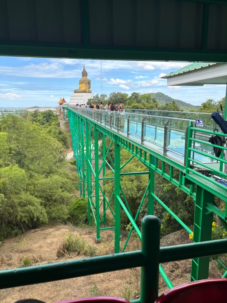 Close-up of the glass Skywalk at Wat Khao Tabaek in Chonburi, Thailand, with panoramic views of the surrounding hills